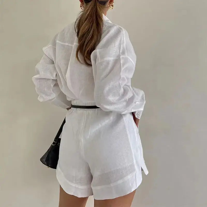 Person wearing a white outfit with a plain background
