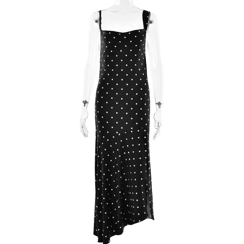 Black dress with white polka dots on a mannequin against a white background
