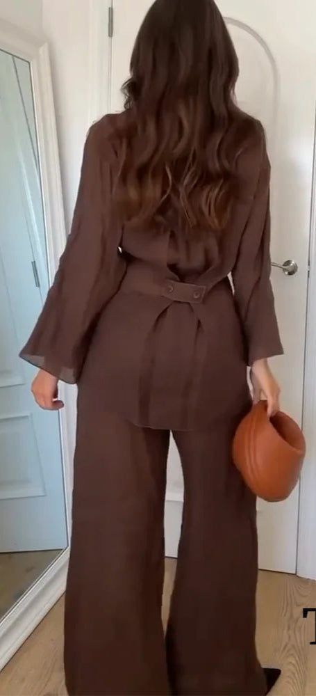 Woman in a brown outfit holding a brown bag