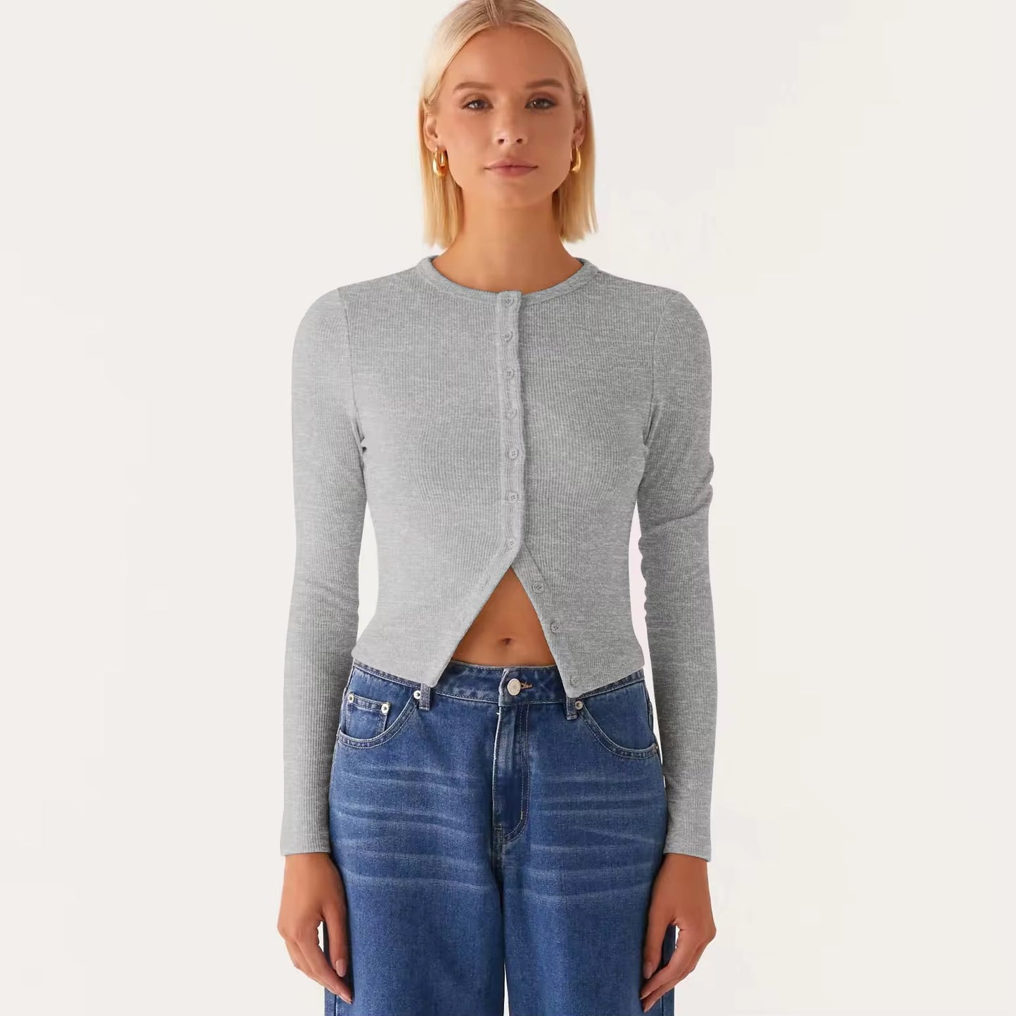 Person wearing a gray cardigan and blue jeans on a white background