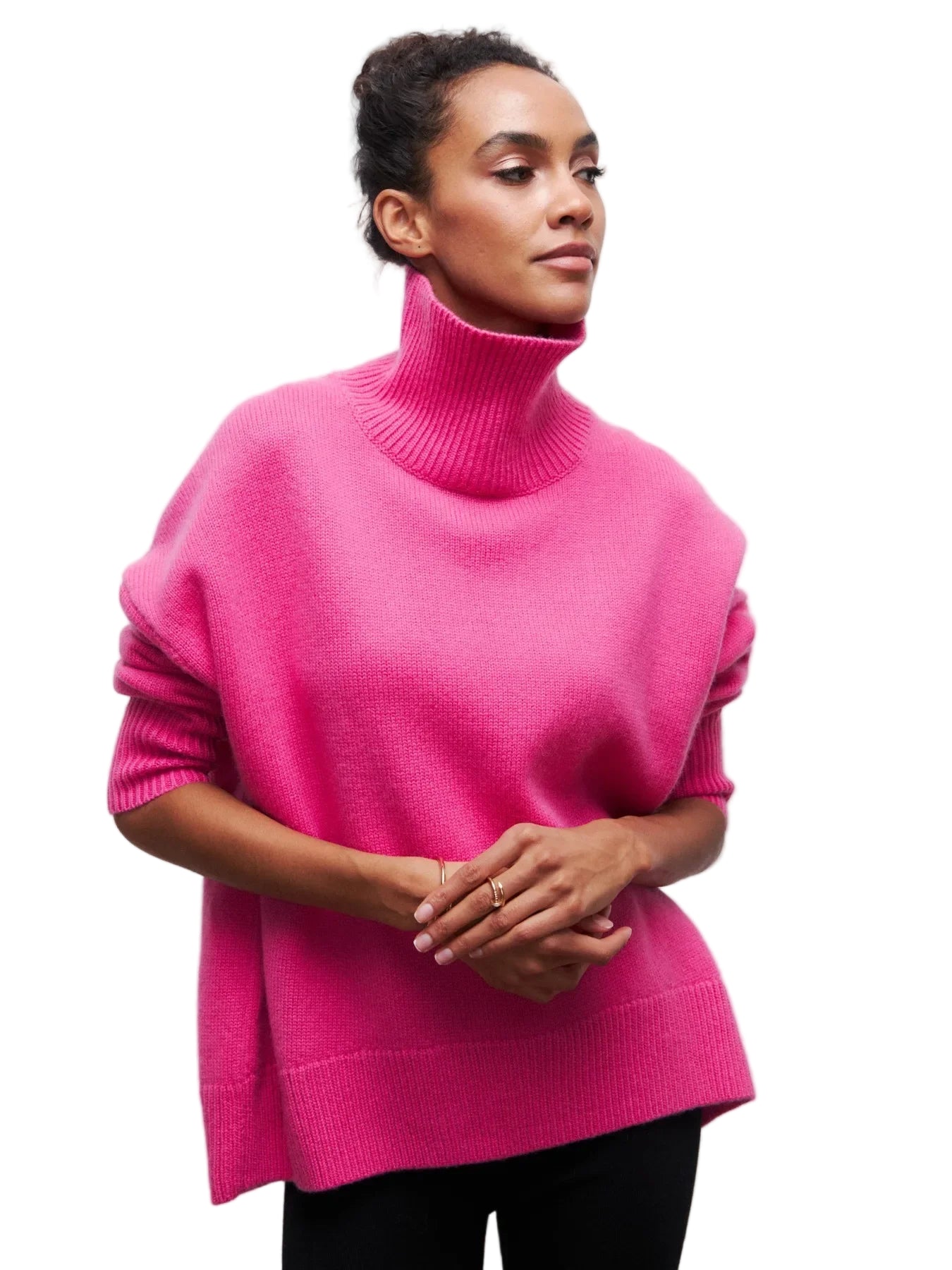 Person wearing a bright pink turtleneck sweater against a white background