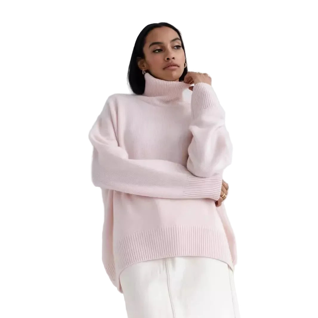 Person wearing a light pink turtleneck sweater against a white background