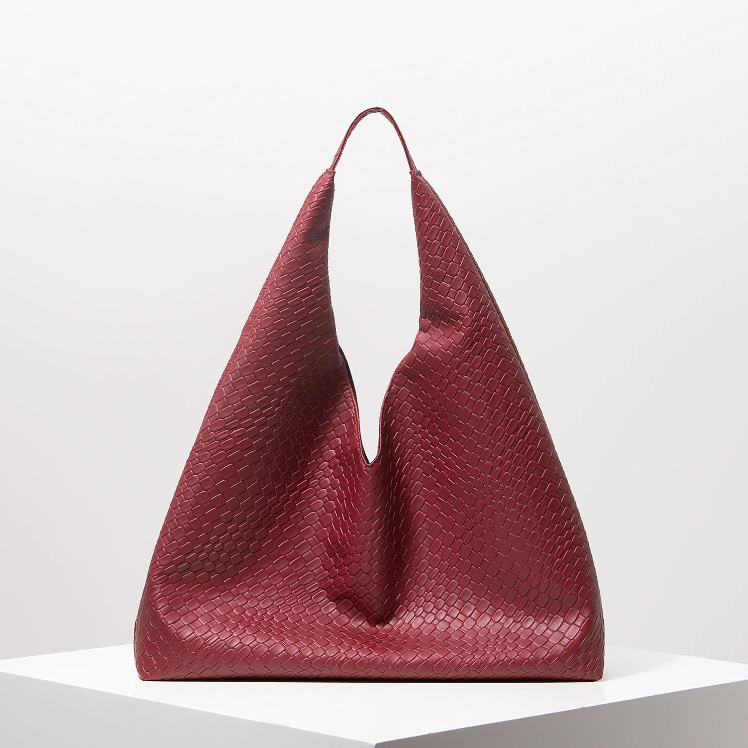 Red textured handbag on a white background
