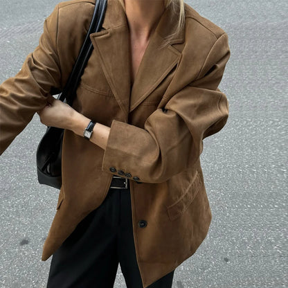 Person wearing a brown coat with a blurred background