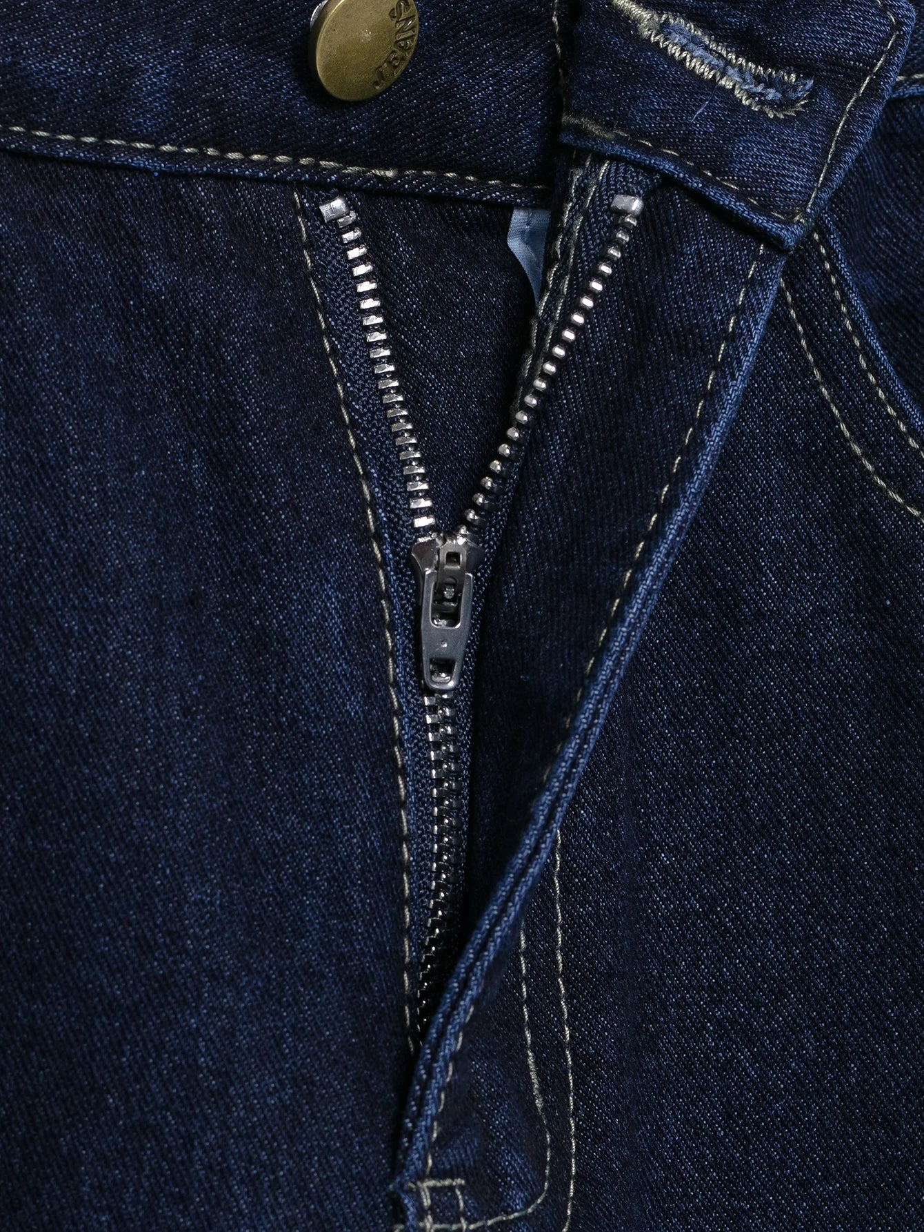 Close-up of a zipper on a dark blue denim fabric