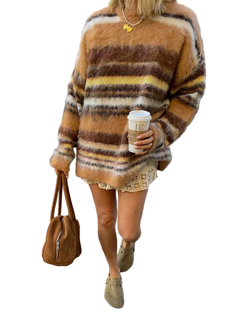 Person wearing a striped sweater and holding a coffee cup on a street.