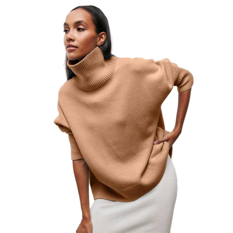 Woman wearing a beige poncho against a white background