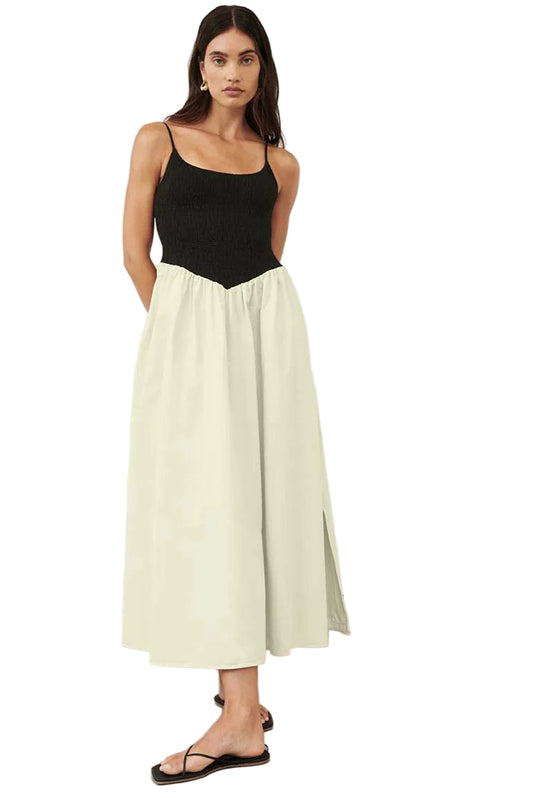 Woman wearing a black and white dress against a white background