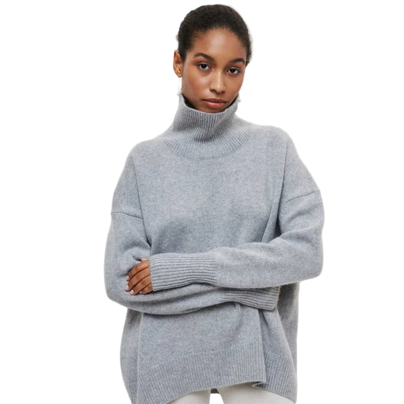 Woman wearing a gray turtleneck sweater on a light gray background