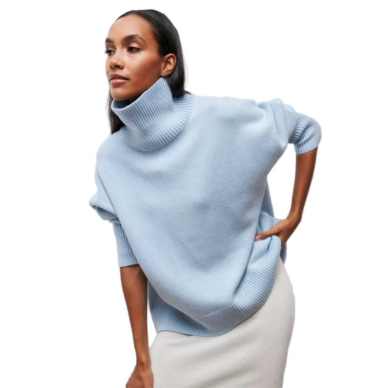 Woman wearing a light blue turtleneck sweater against a white background