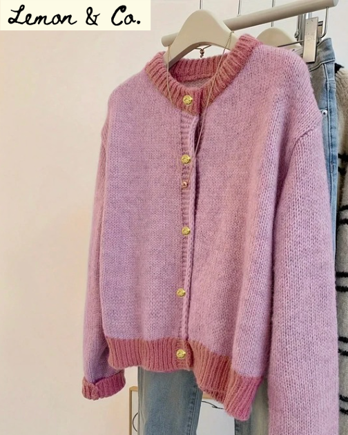 Pink knitted cardigan on a hanger with 'Lemon & Co.' branding.