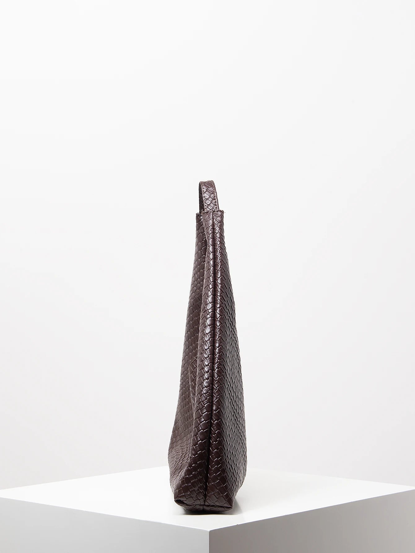 Dark brown textured handbag on a white background